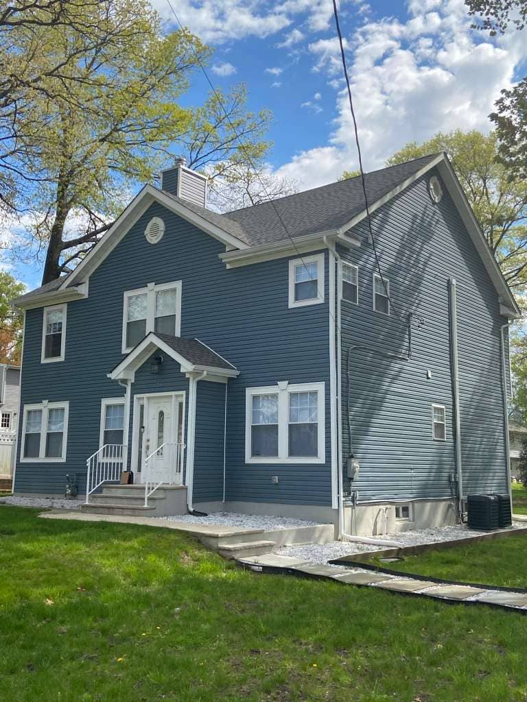Asphalt Shingle Roof Installation with Vent Pipe and Ridge Detail