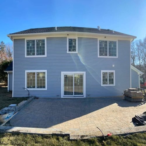 Blue Two-Story Home Exterior Renovation with New Siding and Front Entrance