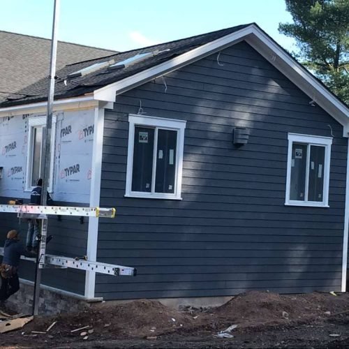 New home construction in progress with Tyvek house wrap installation by Legacy Contractor in Orange County, NJ