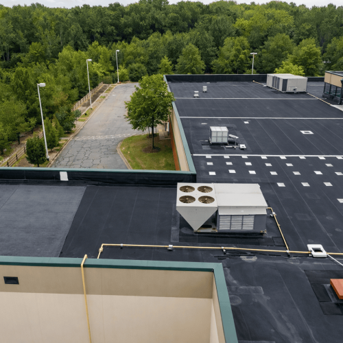 Newly installed commercial flat roof system on a large building to improve waterproofing and energy efficiency.